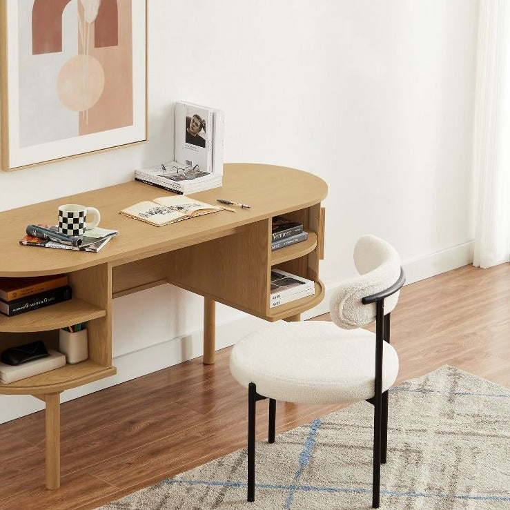 Chaises en bouclette disponibles en gris et crème, pieds en métal noir assortis, style élégant et intemporel.