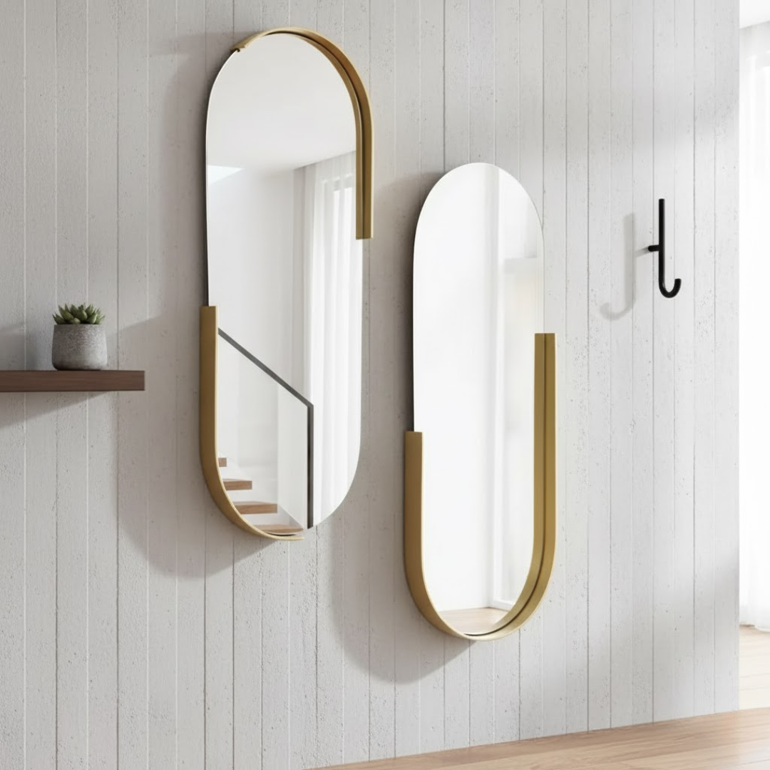 Duo de miroirs ovales 70x40 cm avec un cadre partiel en métal doré, installés sur un mur blanc.