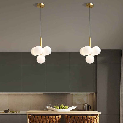 Suspension en laiton à 4 boules blanches